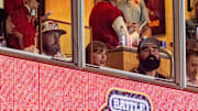 Aug 28, 2025; Kansas City, Missouri, USA; Travis Kelce, Taylor Swift and Jason Kelce watch during the second quarter between the Cincinnati Bearcats and the Nebraska Cornhuskers at GEHA Field at Arrowhead Stadium. Mandatory Credit: Dylan Widger-Imagn Images