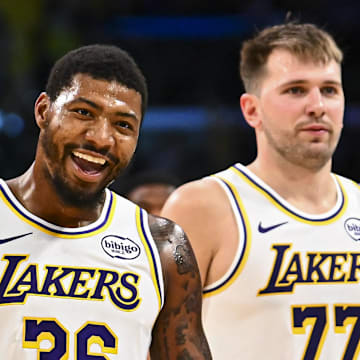 Nov 2, 2025; Los Angeles, California, USA; Los Angeles Lakers guard Marcus Smart (36) reacts with Los Angeles Lakers guard Luka Doncic (77) during a time out against the Miami Heat during the second half at Crypto.com Arena. Mandatory Credit: Jonathan Hui-Imagn Images