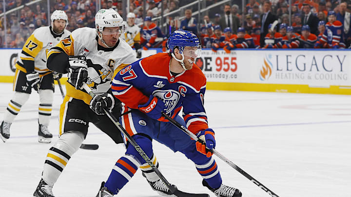 Jan 22, 2026; Edmonton, Alberta, CAN; Pittsburgh Penguins forward Sidney Crosby (87) defends Edmonton Oilers forward Connor McDavid (97) during the first period at Rogers Place. Mandatory Credit: Perry Nelson-Imagn Images