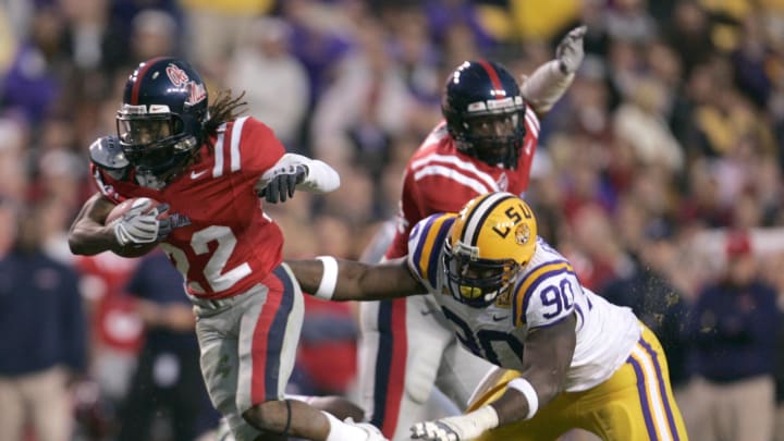 Nov 22, 2008; Baton Rouge, LA, USA; Mississippi Rebels running back Dexter McCluster (22) runs past LSU Tigers defensive tackle Ricky Jean-Francois (90) during the second half at Tiger Stadium in Baton Rouge. Mississippi defeated LSU 31-13.  Mandatory Credit: Matt Stamey-USA TODAY Sports