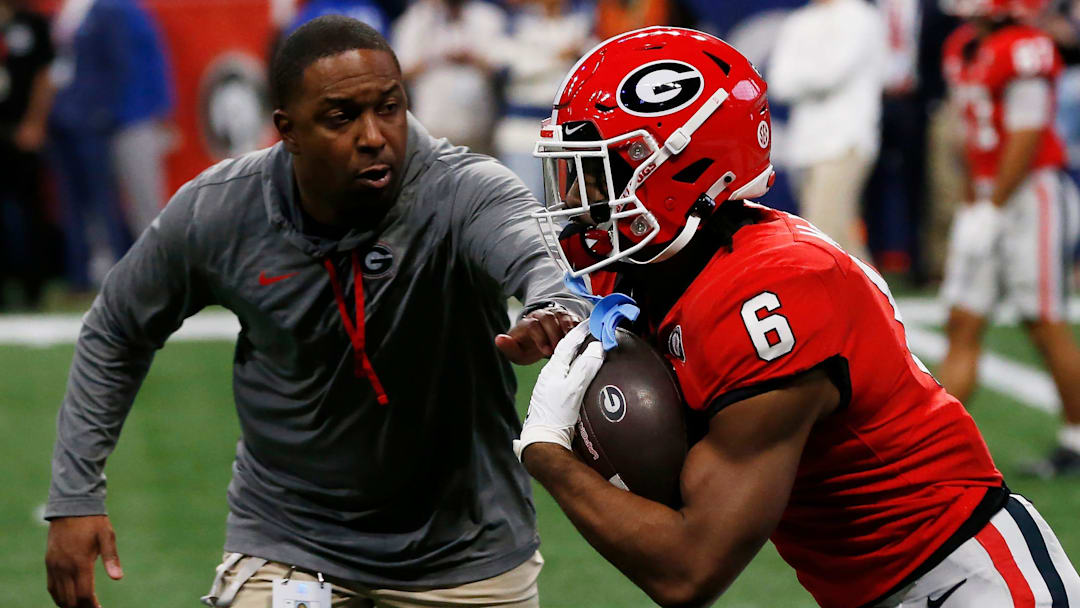 Georgia running back Kenny McIntosh (6) runs a drill with Georgia Wide Receivers Coach Bryan McClendon before the start of the SEC Championship NCAA college football game between LSU and Georgia in Atlanta, on Saturday, Dec. 3, 2022.

News Joshua L Jones