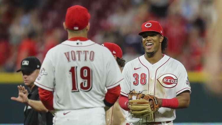Cincinnati Reds second baseman Jose Barrero (38) reacts with first baseman Joey Votto.