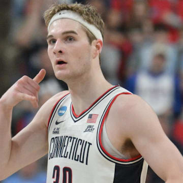 Mar 21, 2025; Raleigh, NC, USA;  Connecticut Huskies forward Liam McNeeley (30) reacts during the first half against the Oklahoma Sooners at Lenovo Center. Mandatory Credit: Zachary Taft-Imagn Images