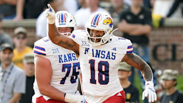 Sep 6, 2025; Columbia, Missouri, USA; Kansas Jayhawks tight end DeShawn Hanika (18) celebrates with offensive lineman Antonio Wilson (76) after scoring a touchdown during the second half against the Missouri Tigers at Faurot Field at Memorial Stadium. Mandatory Credit: Jay Biggerstaff-Imagn Images