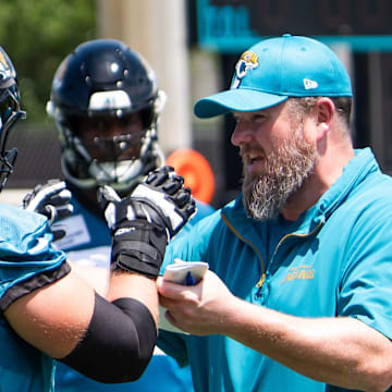 Jacksonville Jaguars Offensive Line Coach Shaun Sarrett coaches Jacksonville Jaguars offensive tackle Cole Van Lanen (70) during the fourth organized team activity at the Miller Electric Center in Jacksonville, Fla. Tuesday, May 27, 2025. [Doug Engle/Florida Times-Union]