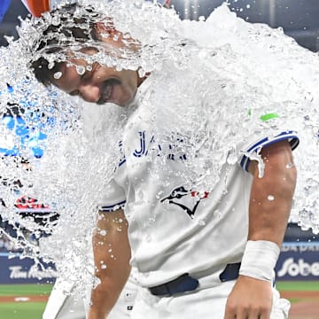 Jul 6, 2025; Toronto, Ontario, CAN;  Toronto Blue Jays left fielder Davis Schneider (36) is doused with ice water as he celebrates a win over the Los Angeles Angels at Rogers Centre. 