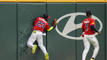 Jul 18, 2025; Cumberland, Georgia, USA; Atlanta Braves center fielder Michael Harris II (23) runs into the outfield fence after making a running catch on a ball hit by New York Yankees shortstop Anthony Volpe (11) (not pictured) during the second inning at Truist Park. Mandatory Credit: Dale Zanine-Imagn Images