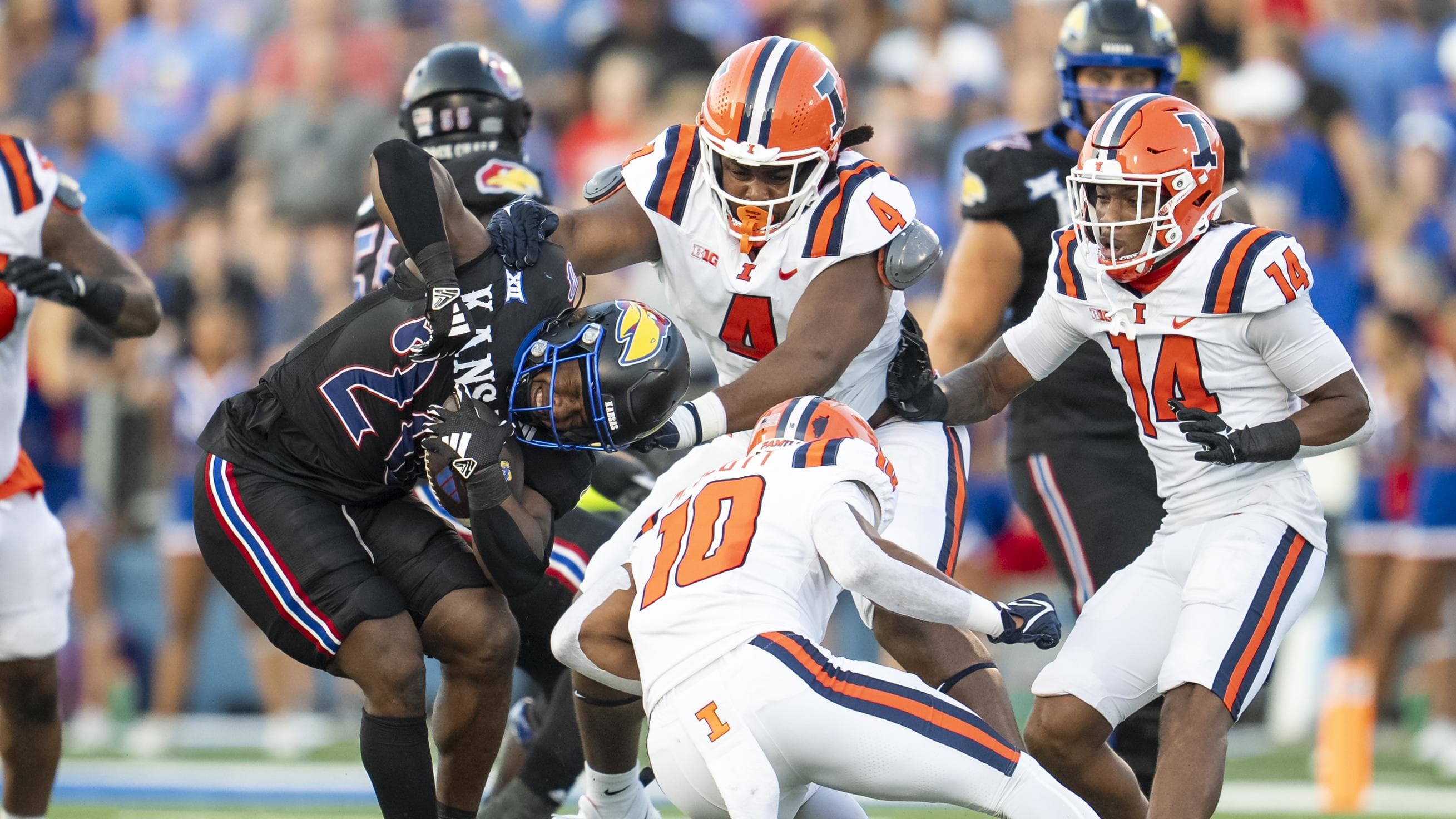 Kansas Jayhawks running back Daniel Hishaw Jr. is tackled by Illinois defensive tackle Jer'Zhan Newton.