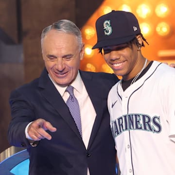 MLB Commissioner Manfred takes a photo with Cijntje after being drafted by the Seattle Mariners with the 15th pick during the first round of the MLB Draft at Cowtown Coliseum. 