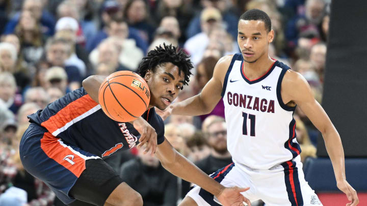 Jan 4, 2024; Spokane, Washington, USA; Pepperdine Waves guard Michael Ajayi (1) loses control of the ball against Gonzaga Bulldogs guard Nolan Hickman (11) in the second half at Spokane Arena. Gonzaga won 86-60. Mandatory Credit: James Snook-USA TODAY Sports