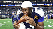 Dallas Cowboys wide receiver George Pickens celebrates by eating turkey after beating the Kansas City Chiefs on Thanksgiving 