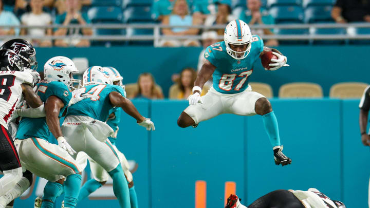 Aug 9, 2024; Miami Gardens, Florida, USA; Miami Dolphins wide receiver Kyric McGowan (87) leaps over Atlanta Falcons tight end John FitzPatrick (87) during preseason at Hard Rock Stadium.