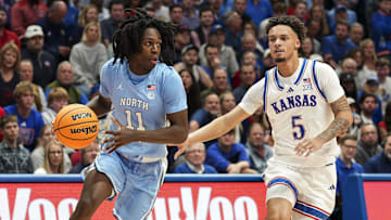 Nov 8, 2024; Lawrence, Kansas, USA; North Carolina Tar Heels guard Ian Jackson (11) drives against Kansas Jayhawks guard Zeke Mayo (5) during the first half at Allen Fieldhouse. Mandatory Credit: Jay Biggerstaff-Imagn Images