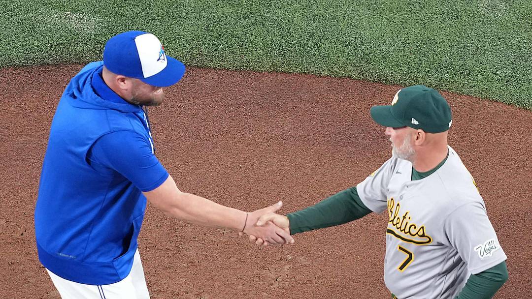 Mar 27, 2026; Toronto, Ontario, CAN; Toronto Blue Jays manager John Schneider (14) shakes hands with Athletics manager Mark Kotsay (7) before a game at Rogers Centre. Mandatory Credit: Nick Turchiaro-Imagn Images