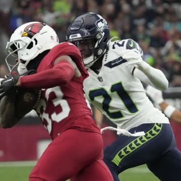 Arizona Cardinals wide receiver Greg Dortch (83) makes a catch against Seattle Seahawks cornerback Devon Witherspoon (21) during the first quarter at State Farm Stadium in Glendale on Jan. 7, 2024.