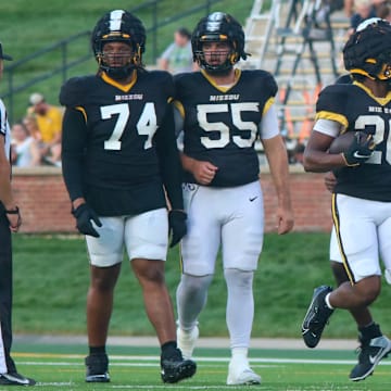 Aug 17, 2024; Columbia, Missouri USA; Missouri Tigers running back Jamal Roberts (20, center) walks with the offensive line during the team's practice at Faurot Field.