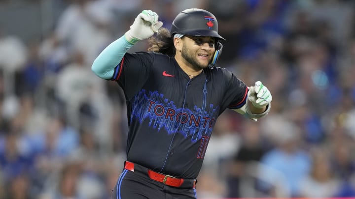 Jul 19, 2024; Toronto, Ontario, CAN; Toronto Blue Jays shortstop Bo Bichette (11) reacts as he suffers a lower body injury as he runs to first base during the sixth inning against the Detroit Tigers at Rogers Centre.