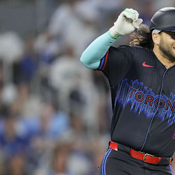 Jul 19, 2024; Toronto, Ontario, CAN; Toronto Blue Jays shortstop Bo Bichette (11) reacts as he suffers a lower body injury as he runs to first base during the sixth inning against the Detroit Tigers at Rogers Centre.