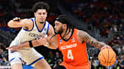 Mar 23, 2025; Milwaukee, WI, USA;  Illinois Fighting Illini guard Kylan Boswell (4) dribbles against Kentucky Wildcats guard Koby Brea (4) during the first half in the second round of the NCAA Tournament at Fiserv Forum. Mandatory Credit: Benny Sieu-Imagn Images