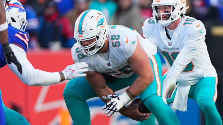 Jan 15, 2023; Orchard Park, New York, USA; Miami Dolphins guard Connor Williams (58) snaps the ball to Miami Dolphins quarterback Skylar Thompson (19) during a wild card game against the Buffalo Bills at Highmark Stadium. Mandatory Credit: Gregory Fisher-USA TODAY Sports