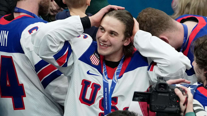 Feb 22, 2026; Milan, Italy; Jack Hughes of the United States celebrates after winning the men's ice hockey gold medal game during the Milano Cortina 2026 Olympic Winter Games at Milano Santagiulia Ice Hockey Arena. Mandatory Credit: James Lang-Imagn Images