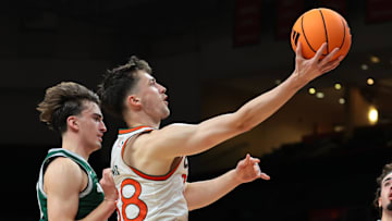 Nov 3, 2025; Coral Gables, Florida, USA; Miami Hurricanes forward Timotej Malovec (88) drives to the basket against Jacksonville Dolphins guard Hayden Wood (8) during the first half at Watsco Center. Mandatory Credit: Sam Navarro-Imagn Images