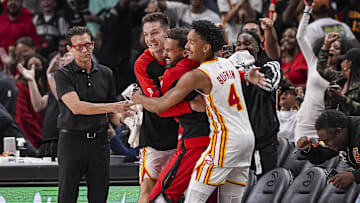 Atlanta Hawks head coach Quin Snyder and guards Vit Krejci, Trae Young, and Kobe Bufkin, react after the Hawks hit a three point shot against the Indiana Pacers with less than a second remaining