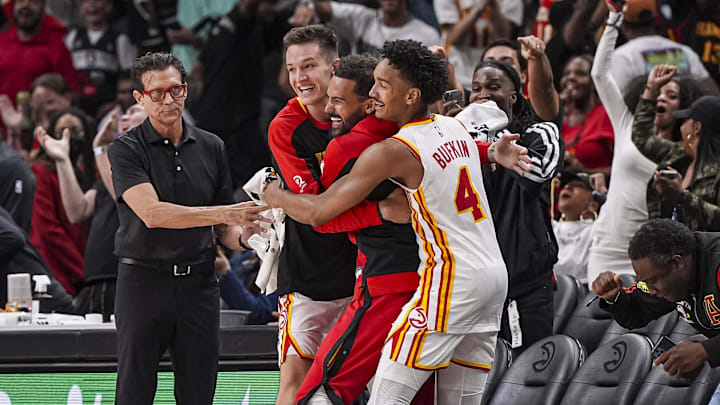Atlanta Hawks head coach Quin Snyder and guards Vit Krejci, Trae Young, and Kobe Bufkin, react after the Hawks hit a three point shot against the Indiana Pacers with less than a second remaining