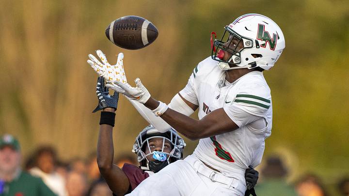 Lawrence North High School sophomore Monshun Sales (1) makes a catch in the end zone to score while being defended by Lawrence Central High School junior DJ Summers (13) during the first half of an IHSAA varsity football game, Friday, Aug. 23, 2024, at Lawrence Central High School.