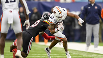 Dec 30, 2023; Nashville, TN, USA;  Auburn Tigers wide receiver Caleb Burton III (10) runs the ball against the Maryland Terrapins during the first half at Nissan Stadium. Mandatory Credit: Steve Roberts-Imagn Images