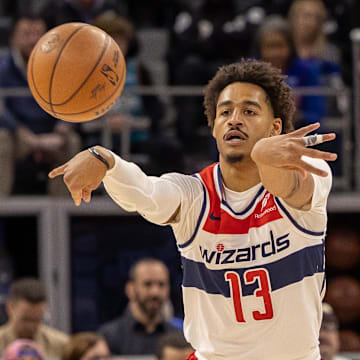 Mar 11, 2025; Detroit, Michigan, USA; Washington Wizards guard Jordan Poole (13) passes the ball against the Detroit Pistons during the first half at Little Caesars Arena. Mandatory Credit: David Reginek-Imagn Images