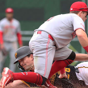 May 21, 2025; Pittsburgh, Pennsylvania, USA;  Cincinnati Reds second baseman Matt McLain (9) tags Pittsburgh Pirates second baseman Adam Frazier (26) out at second base on a steal attempt during the eighth inning at PNC Park. Mandatory Credit: Charles LeClaire-Imagn Images