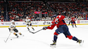 Oct 15, 2024; Washington, District of Columbia, USA; Washington Capitals left wing Alex Ovechkin (8) shoots the puck as Vegas Golden Knights center Brett Howden (21) defends in the first period at Capital One Arena. Mandatory Credit: Geoff Burke-Imagn Images