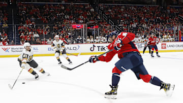 Oct 15, 2024; Washington, District of Columbia, USA; Washington Capitals left wing Alex Ovechkin (8) shoots the puck as Vegas Golden Knights center Brett Howden (21) defends in the first period at Capital One Arena. Mandatory Credit: Geoff Burke-Imagn Images