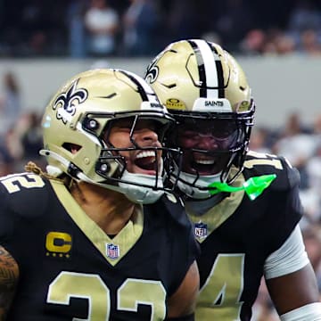 Sep 15, 2024; Arlington, Texas, USA; New Orleans Saints safety Tyrann Mathieu (32) celebrates with New Orleans Saints cornerback Alontae Taylor (1) and New Orleans Saints cornerback Kool-Aid McInstry(14) after making an interception during the second half against the Dallas Cowboys at AT&T Stadium. Mandatory Credit: Kevin Jairaj-Imagn Images