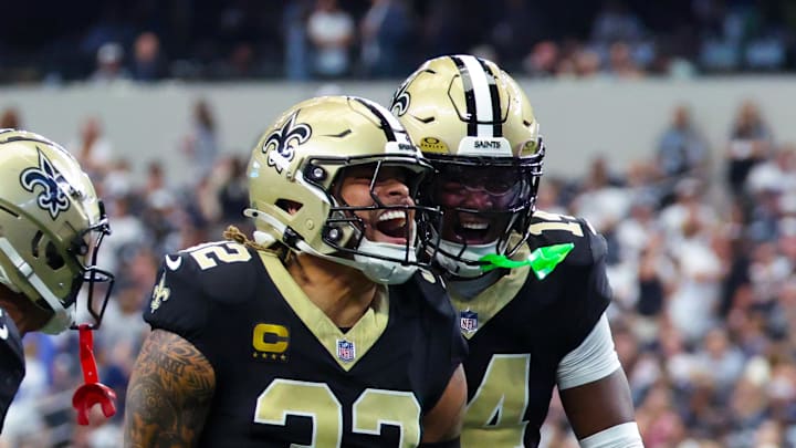 Sep 15, 2024; Arlington, Texas, USA; New Orleans Saints safety Tyrann Mathieu (32) celebrates with New Orleans Saints cornerback Alontae Taylor (1) and New Orleans Saints cornerback Kool-Aid McInstry(14) after making an interception during the second half against the Dallas Cowboys at AT&T Stadium. Mandatory Credit: Kevin Jairaj-Imagn Images