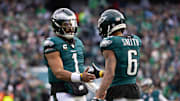 Dec 8, 2024; Philadelphia, Pennsylvania, USA;  Philadelphia Eagles wide receiver DeVonta Smith (6) and quarterback Jalen Hurts (1) celebrate their touchdown connection against the Carolina Panthers during the second quarter at Lincoln Financial Field. Mandatory Credit: Bill Streicher-Imagn Images