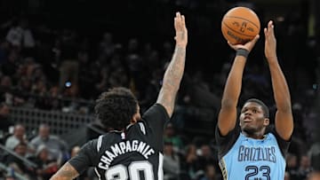 Nov 18, 2025; San Antonio, Texas, USA;  Memphis Grizzlies forward Cedric Coward (23) shoots in front of San Antonio Spurs forward Julian Champagnie (30) in the second half at Frost Bank Center. Mandatory Credit: Daniel Dunn-Imagn Images