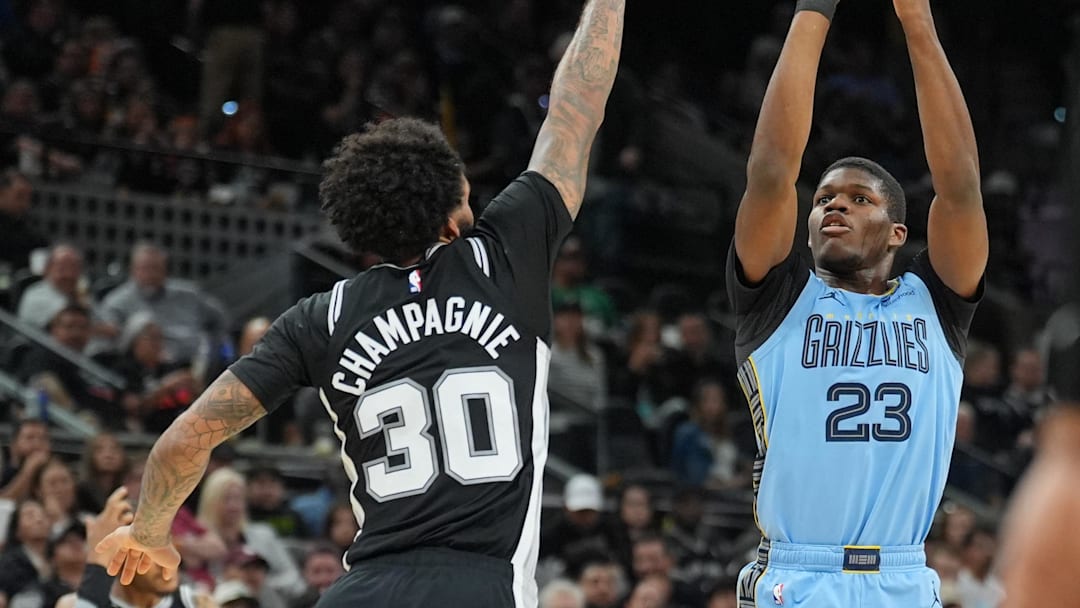 Nov 18, 2025; San Antonio, Texas, USA;  Memphis Grizzlies forward Cedric Coward (23) shoots in front of San Antonio Spurs forward Julian Champagnie (30) in the second half at Frost Bank Center. Mandatory Credit: Daniel Dunn-Imagn Images