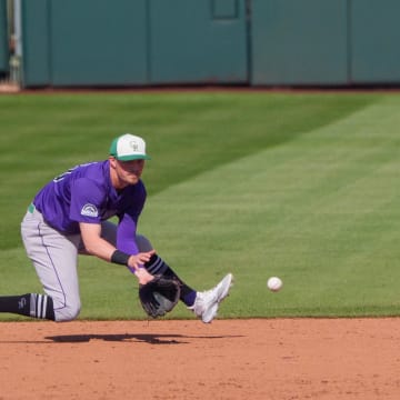 Mar 17, 2024; Scottsdale, Arizona, USA; Colorado Rockies infielder Aaron Schunk (80) fields a ground ball in the sixth inning during a spring training game against the San Francisco Giants at Scottsdale Stadium.