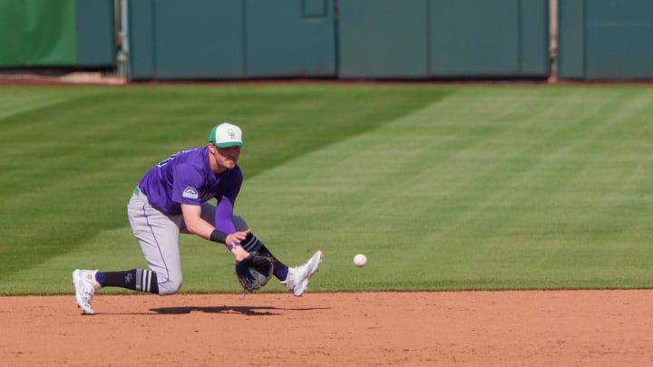 Mar 17, 2024; Scottsdale, Arizona, USA; Colorado Rockies infielder Aaron Schunk (80) fields a ground ball in the sixth inning during a spring training game against the San Francisco Giants at Scottsdale Stadium.
