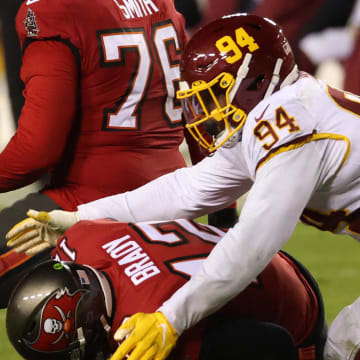 Jan 9, 2021; Landover, Maryland, USA; Tampa Bay Buccaneers quarterback Tom Brady (12) is sacked by Washington Football Team nose tackle Daron Payne (94) in the fourth quarter at FedExField. Mandatory Credit: Geoff Burke-USA TODAY Sports