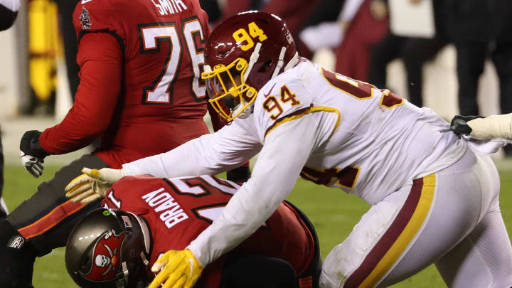 Jan 9, 2021; Landover, Maryland, USA; Tampa Bay Buccaneers quarterback Tom Brady (12) is sacked by Washington Football Team nose tackle Daron Payne (94) in the fourth quarter at FedExField. Mandatory Credit: Geoff Burke-USA TODAY Sports