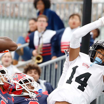 Aliquipp'a Qa'Lil Goode catches a 20-yard touchdown pass on fourth down in front of McKeesport's Javien Robinson (6), Akeen Cochran (2) and Brian Jones (8) with 2 minutes, 5 seconds remaining in the WPIAL Class 4A title game Saturday at Pine-Richland High School. The Quips won their record 21st district crown