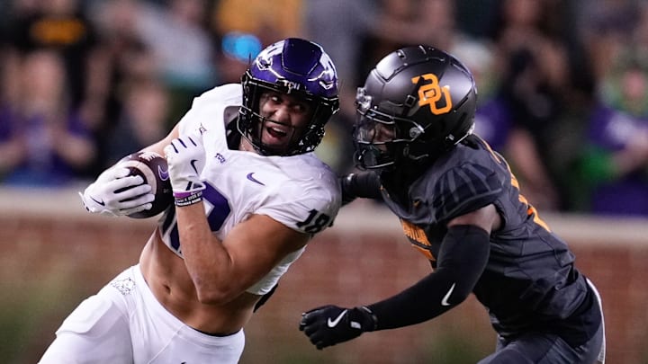 Nov 2, 2024; Waco, Texas, USA;  A TCU Horned Frog player runs the ball aganst Baylor Bears safety Carl Williams IV (15) during the first half at McLane Stadium. Mandatory Credit: Chris Jones-Imagn Images