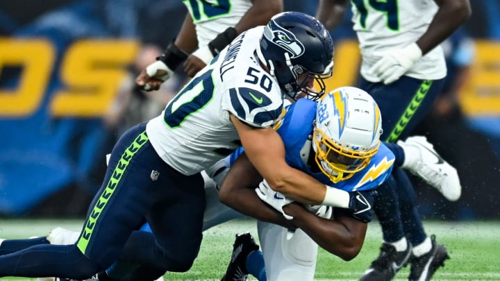 Aug 10, 2024; Inglewood, California, USA; Seattle Seahawks linebacker Patrick O'Connell (50) tackles Los Angeles Chargers running back Isaiah Spiller (28) during the fourth quarter at SoFi Stadium. Mandatory Credit: Jonathan Hui-USA TODAY Sports