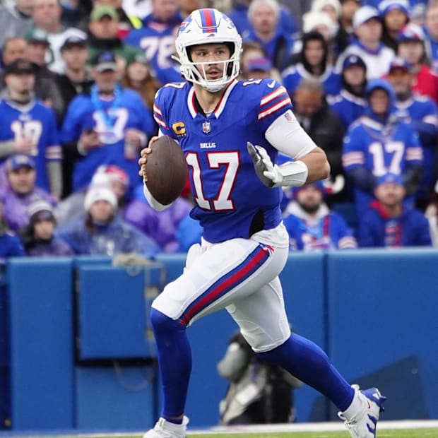Buffalo Bills quarterback Josh Allen rolls out looking to throw the ball against the New York Jets