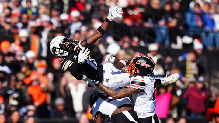 Oklahoma State Cowboys cornerback Korie Black (2) and safety Trey Rucker (9) defend on Colorado Buffaloes wide receiver Travis Hunter.