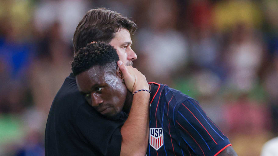 Mauricio Pochettino (left) hugging Folarin Balogun.