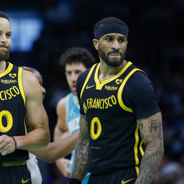 Mar 29, 2024; Charlotte, North Carolina, USA; Golden State Warriors guards Stephen Curry (30) and Gary Payton II look to the bench during a break in the action against the Charlotte Hornets during the first quarter at Spectrum Center. Mandatory Credit: Nell Redmond-USA TODAY Sports